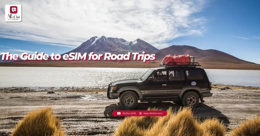 SUV with roof luggage beside a lake and mountains, illustrating eSIM and offline-map preparation for a road trip - AloOui eSIM